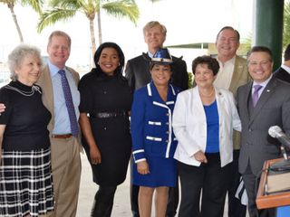 (Left to Right:) Broward Commissioners Sue Gunzburger, Tim Ryan, Vice Mayor Barbara Sharief, Congresswoman Frederica Wilson, Congresswoman Lois Frankel, Commissioner Chip LaMarca. (In back:) Port Everglades CEO Steve Cernak, Greater Fort Lauderdale Alliance CEO Bob Swindell