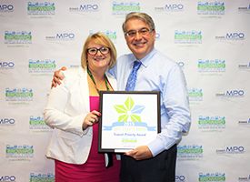 Broward MPO Executive Director Gregory Stuart awards Fort Lauderdale Transportation and Mobility Director Diane Alarcon