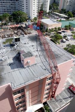 Crane Spans Maracay Condominium Roof