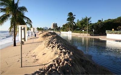 Sand piled along beach and flooded A1A