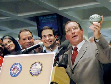 Senate President Kenneth Pruitt holds up a stone entitled 